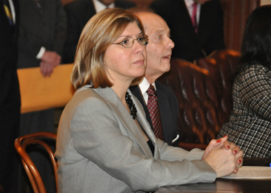 Senator Nellie Pou, D-Passaic, sitting at her desk with her husband during the reorganization of the 215th State Legislature