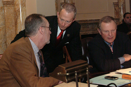 From left to right: Senators Jim Whelan, D-Atlantic, Jeff Van Drew, D-Cape May and Cumberland, and Raymond J. Lesniak, D-Union, confer about legislation prior to a vote.