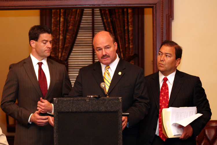 Senator Fred Madden, D-Gloucester and Camden, speaks at a news conference about the need for a bill to require legislators to disclose the source of any income, direct or indirect, derived from public sources, while Senators Bill Baroni, R-Mercer and Middlesex, and Kevin O’Toole, R-Essex, Bergen and Passaic, look on.