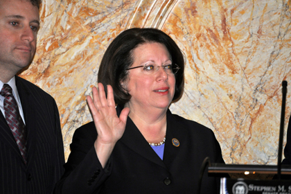 Senator Linda Greenstein, D-Middlesex and Mercer, with son Evan, takes the oath of office.